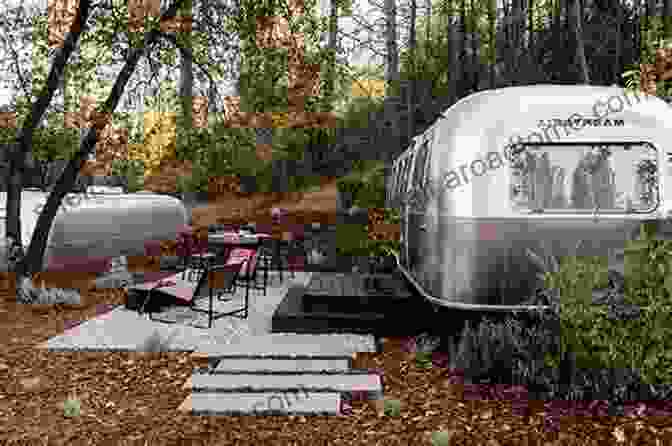 A Gleaming Airstream RV Parked In A Picturesque Wilderness Setting, Surrounded By Towering Trees And A Sparkling River. Airstream: The Silver RV (Shire Library USA)