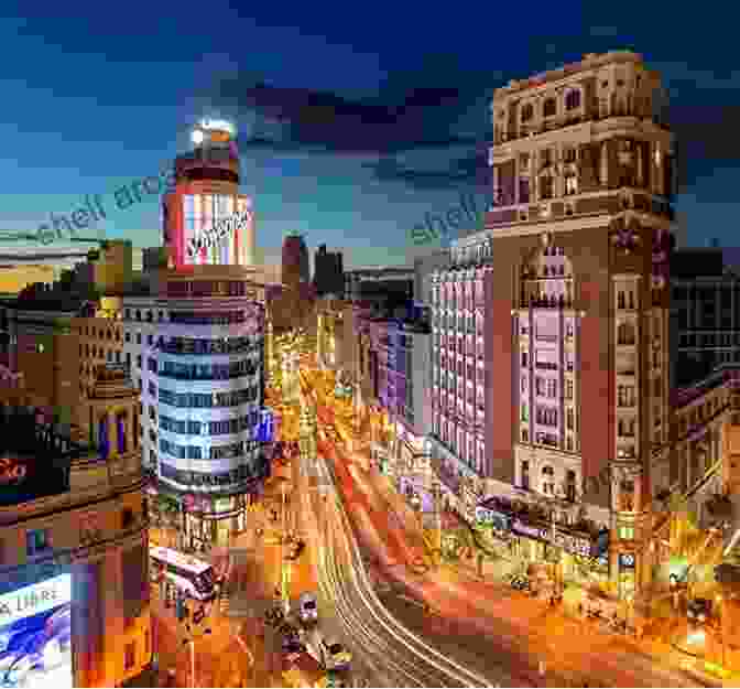 A Vibrant Street Scene In Madrid, Spain, With Bustling Crowds, Colorful Buildings, And The Iconic Gran Via Geography Of Spain Myscha Theriault